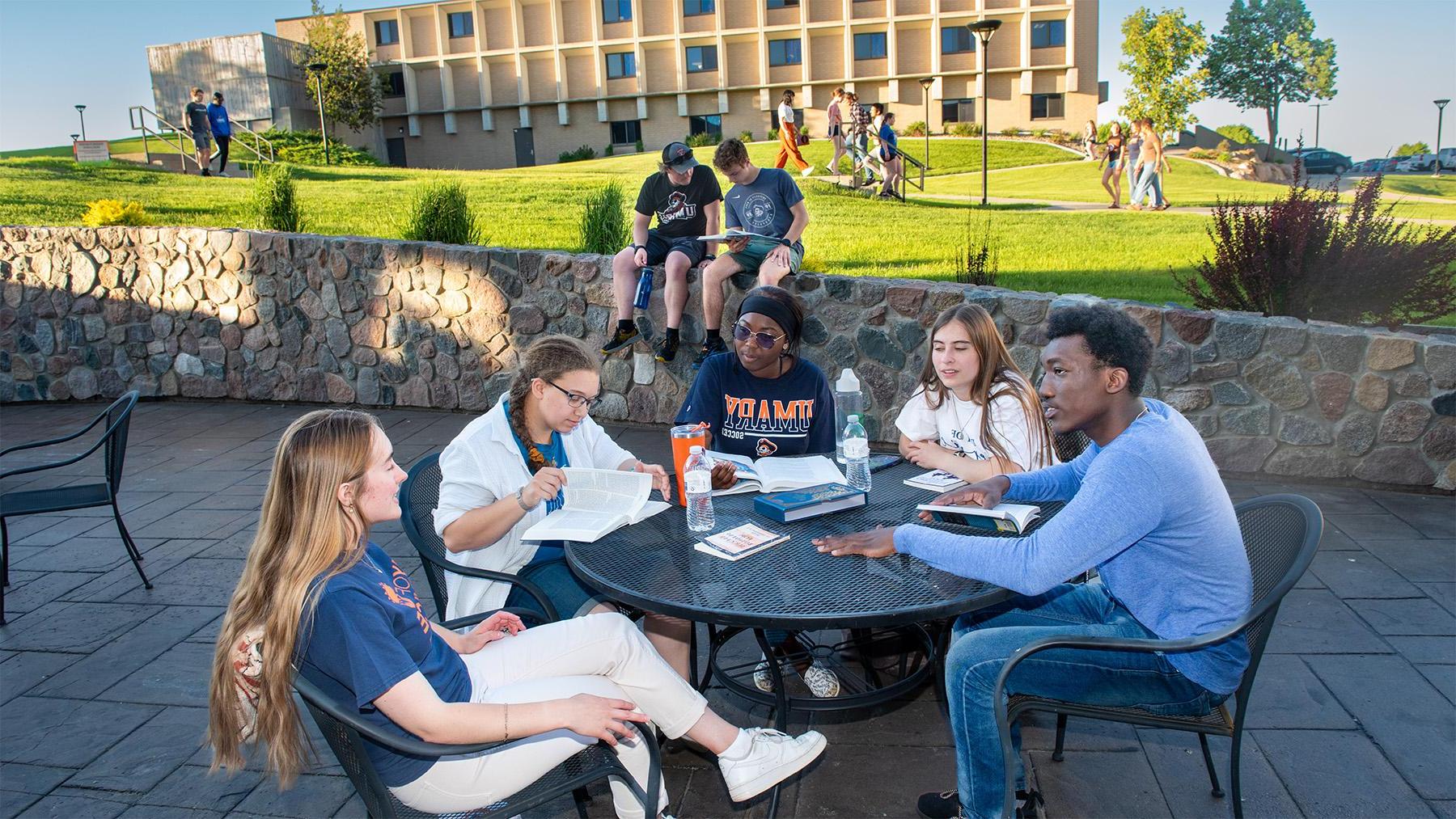 Students studying outside on the patio